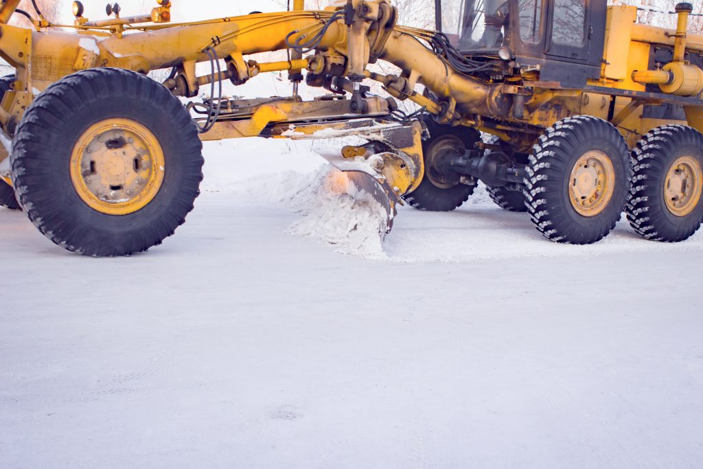 Motor Grader Plowing Snow