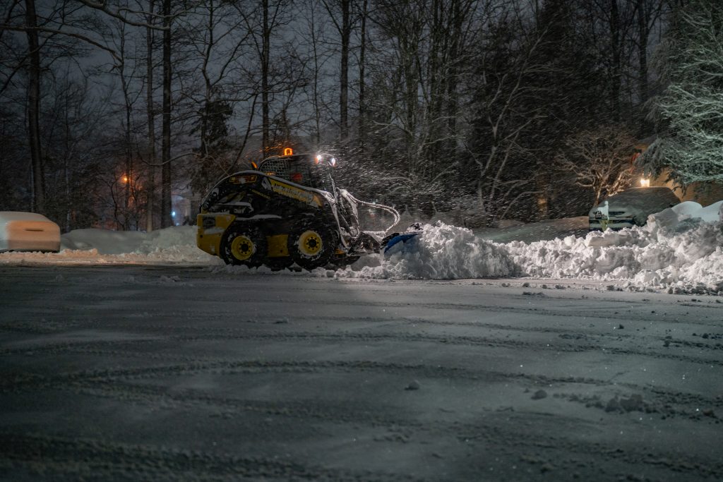 New Holland L230 skid steer plowing snow with a KAGE SnowFire blade